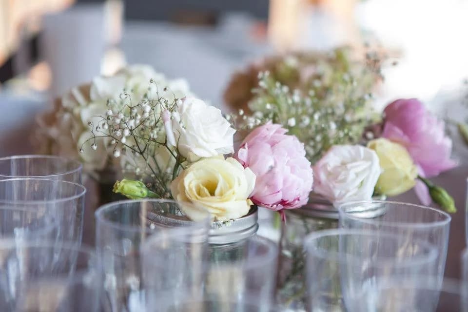 Elegant pink and white rose centerpieces in mason jars at Moose Hollow Lodge in Pigeon Forge.