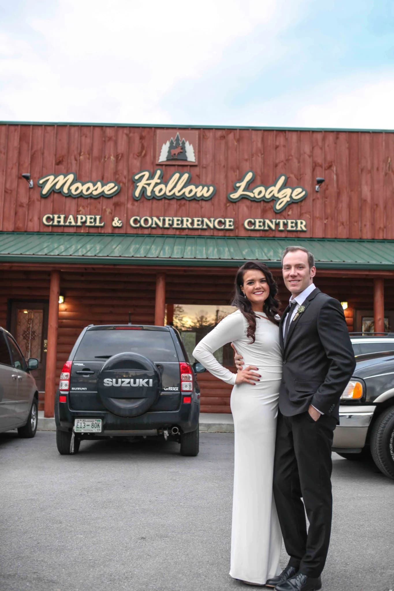 Newlyweds posing outside the wedding chapel at Moose Hollow Lodge in Pigeon Forge near the Smoky Mountains
