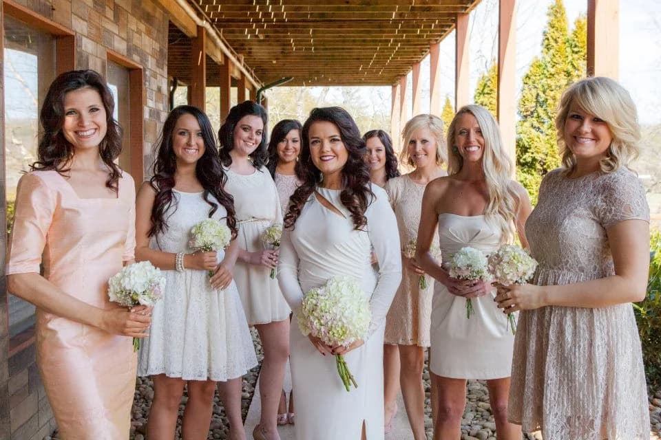 Bride and bridesmaids with bouquets on a covered deck at Moose Hollow Lodge in Pigeon Forge near the Smoky Mountains
