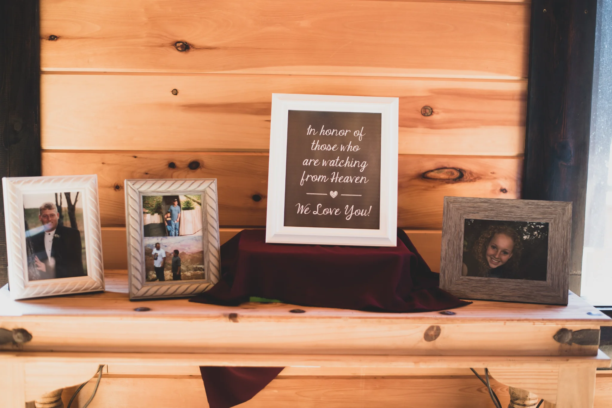 Rustic wedding memorial display with framed photos and sign at Moose Hollow Lodge in Pigeon Forge