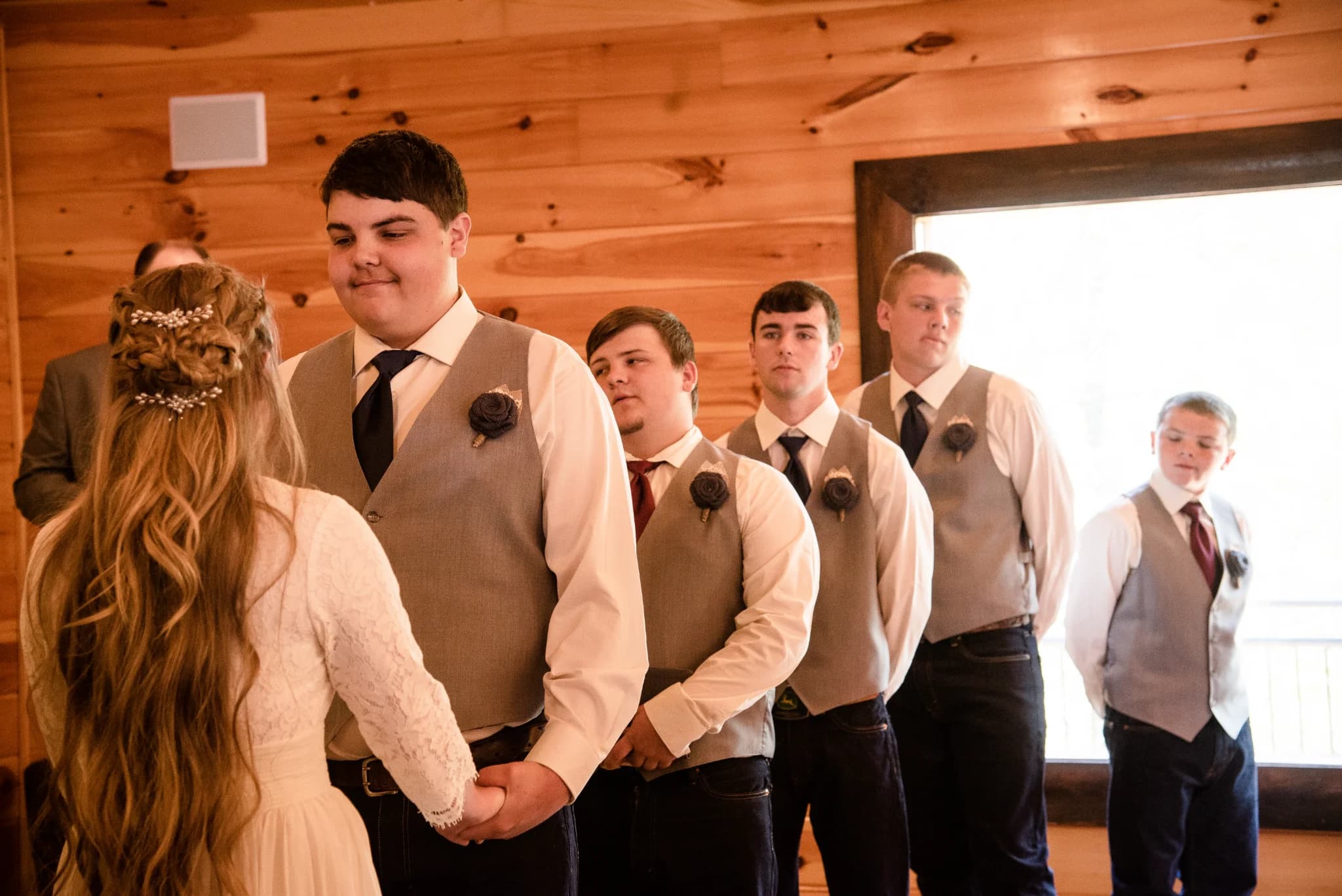 Rustic indoor wedding ceremony with groom and groomsmen at Moose Hollow Lodge in Pigeon Forge