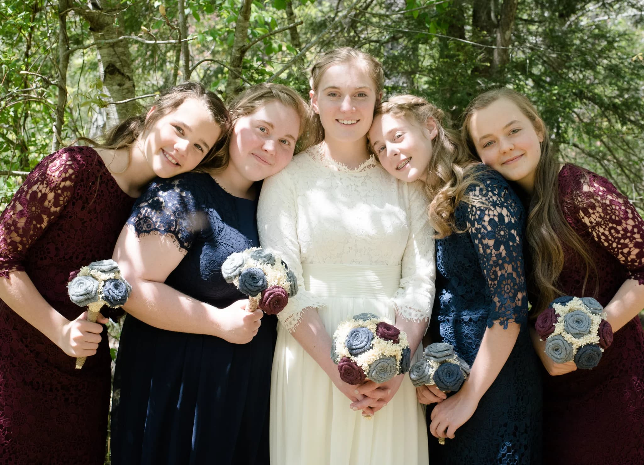 Bride and bridesmaids with bouquets in Smoky Mountains forest at Moose Hollow Lodge in Pigeon Forge