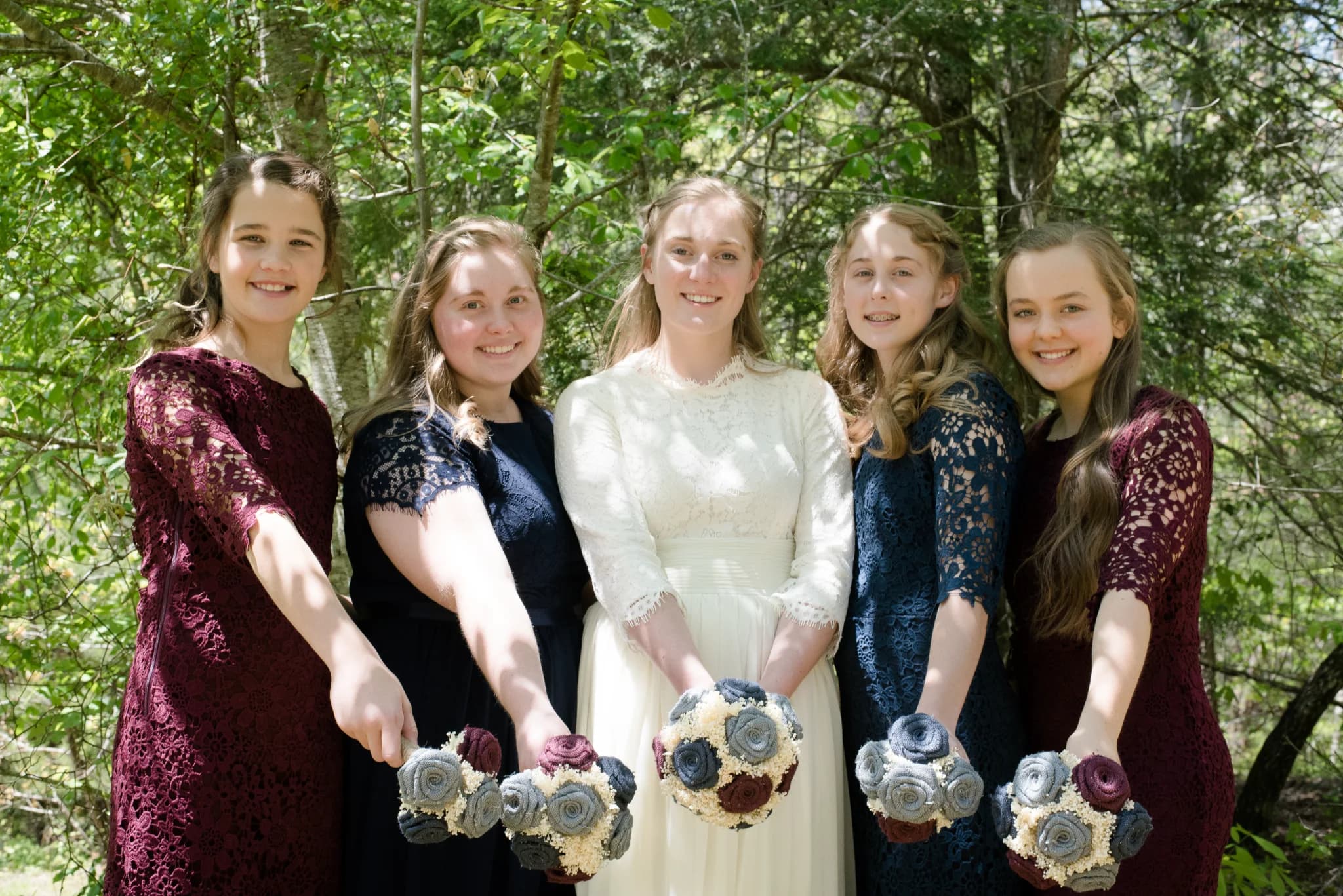 Bridal party with bouquets in a wooded setting at Moose Hollow Lodge in Pigeon Forge near Smoky Mountains