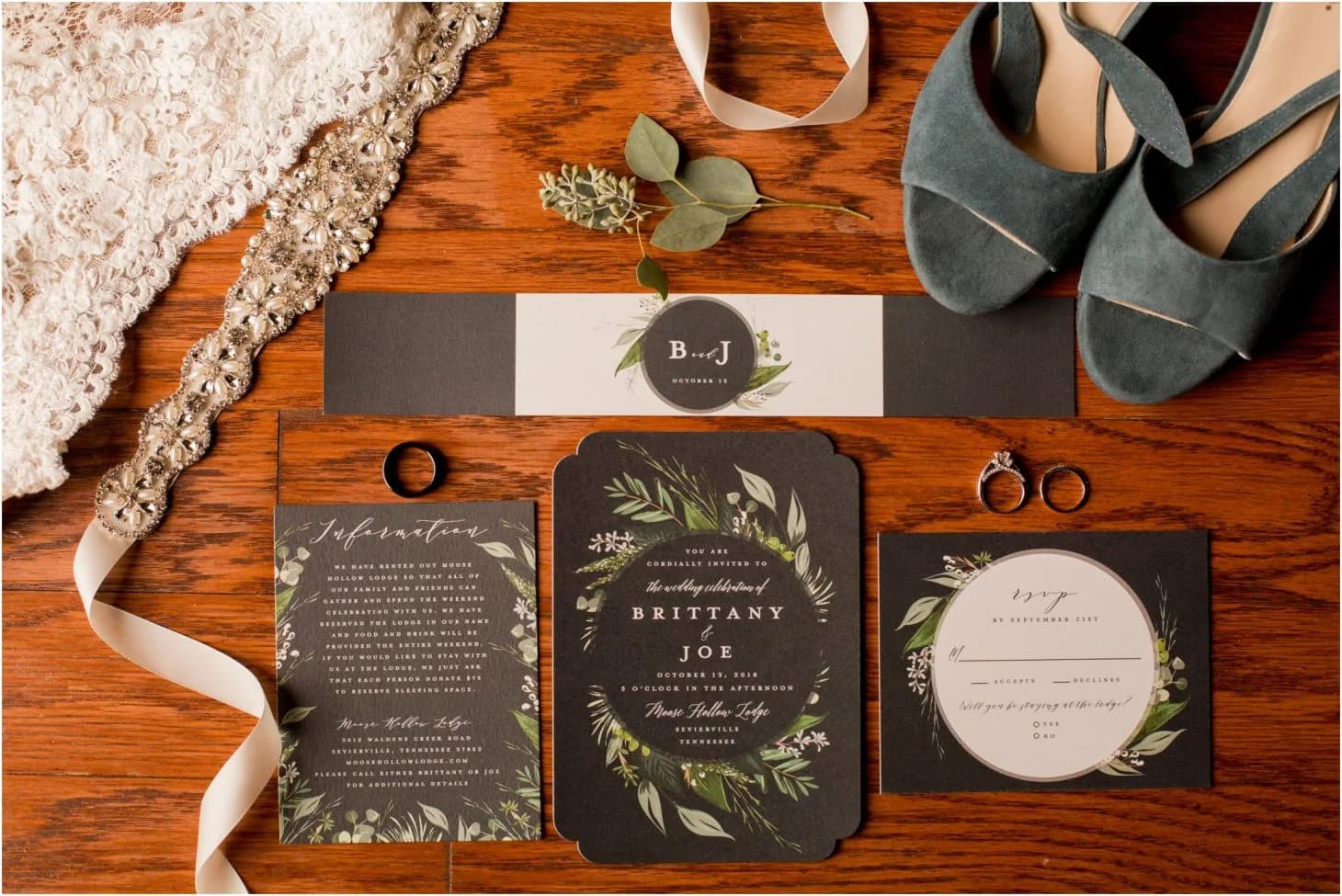 Wedding invitation flat lay with rings and bridal shoes at Moose Hollow Lodge in Pigeon Forge