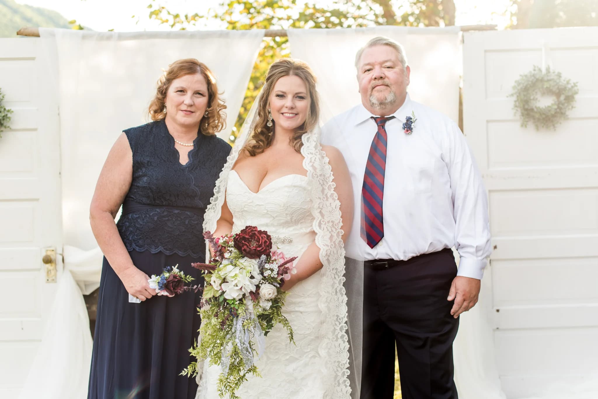 Bride and parents at rustic outdoor wedding altar at Moose Hollow Lodge near Dollywood in the Smoky Mountains