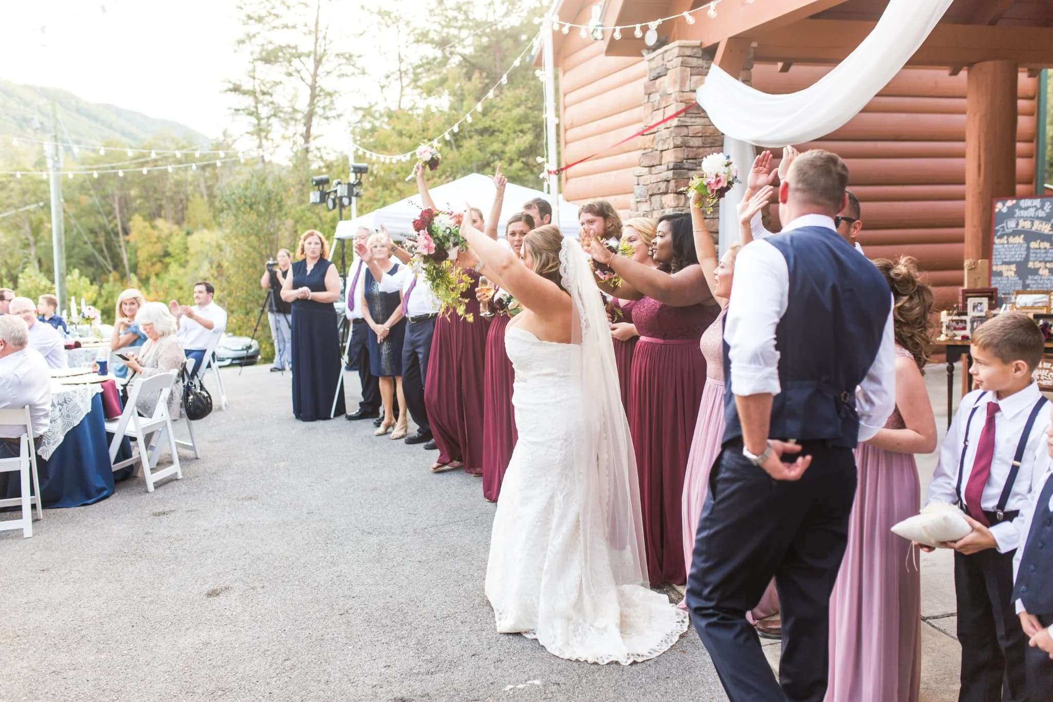 Bride tossing bouquet at outdoor wedding reception near Great Smoky Mountains at Moose Hollow Lodge in Pigeon Forge