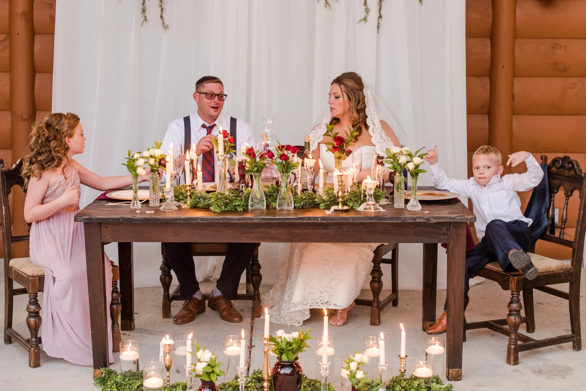 Wedding reception head table with elegant candlelight and floral decor at Moose Hollow Lodge in Pigeon Forge