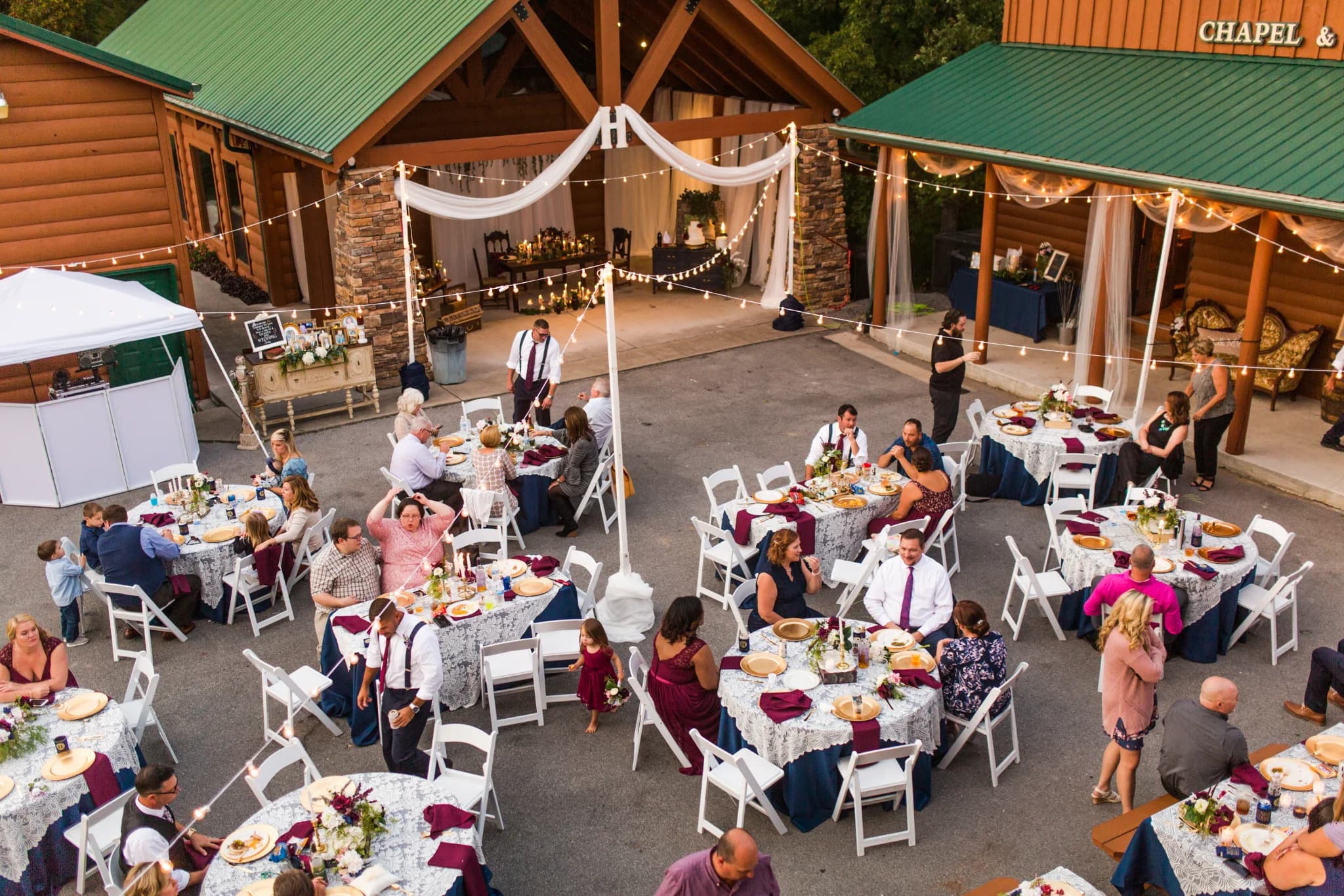 Outdoor wedding reception with string lights and round tables at Moose Hollow Lodge in Pigeon Forge near Dollywood