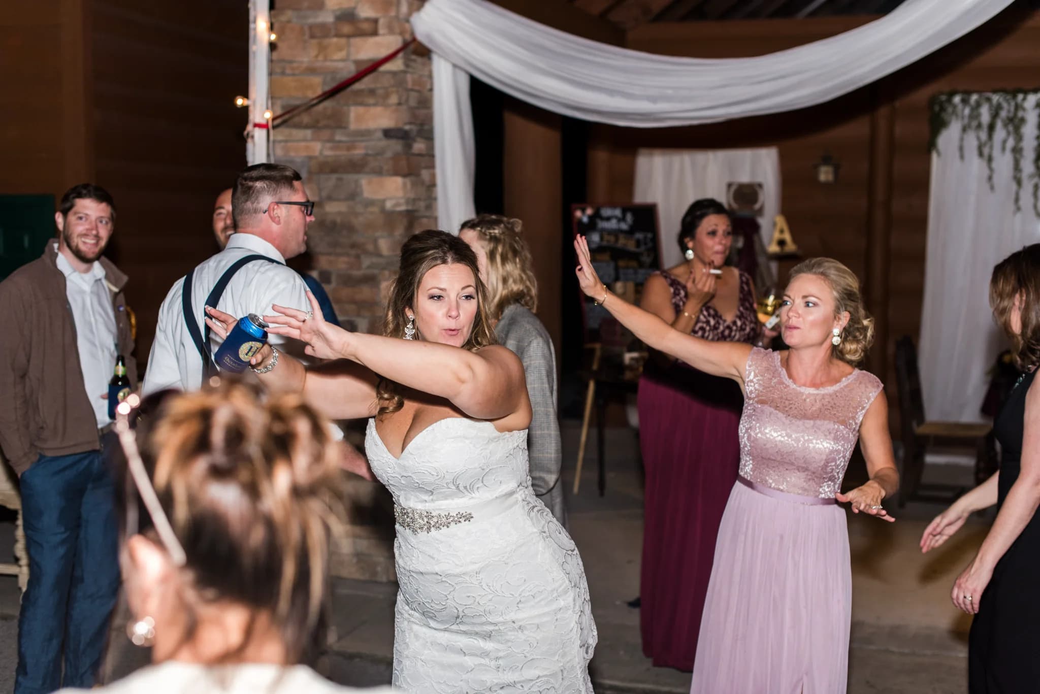 Wedding guests dancing at a rustic reception pavilion near the Smoky Mountains at Moose Hollow Lodge in Pigeon Forge