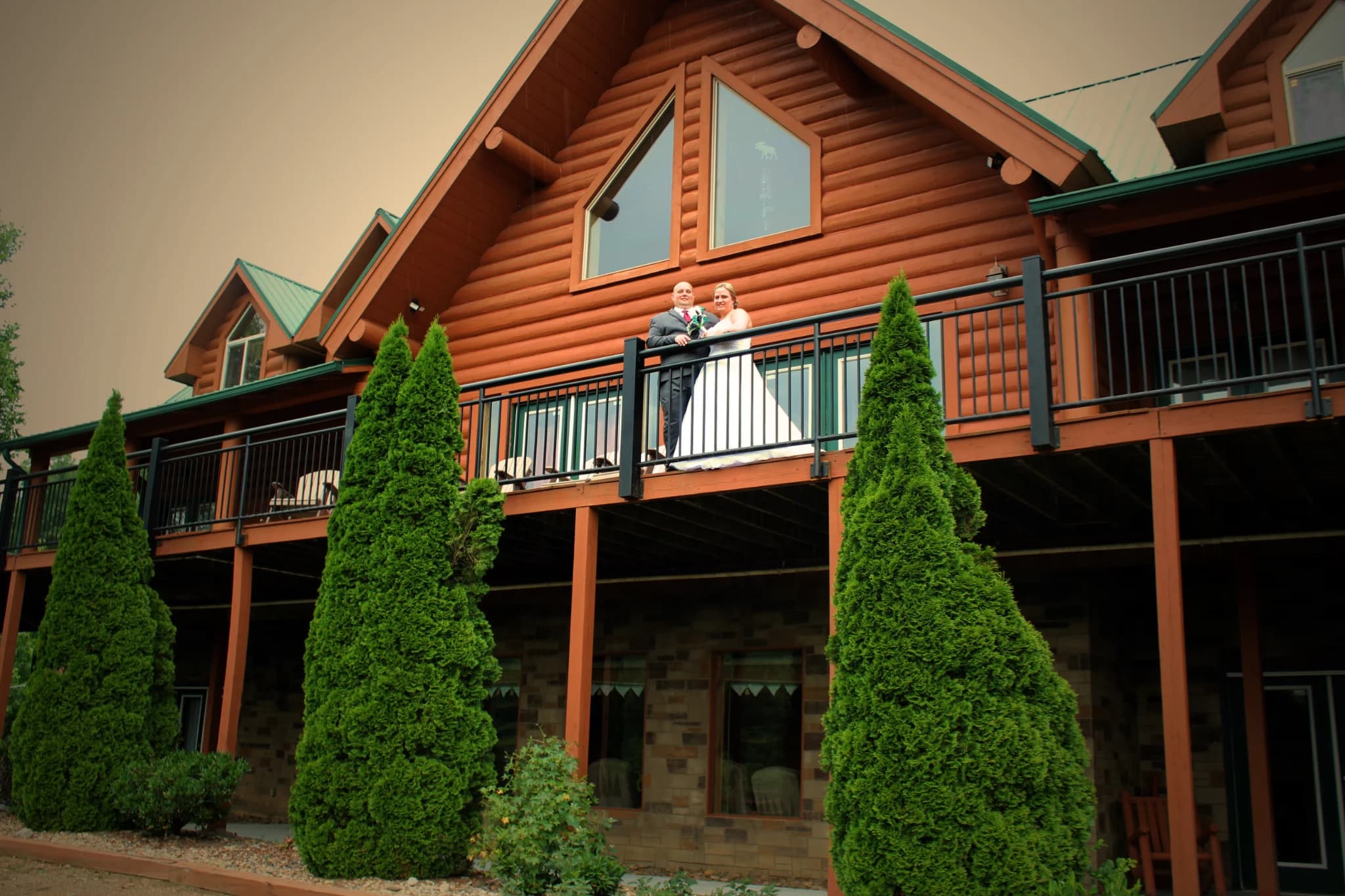 Wedding couple on cabin balcony near Dollywood and Smoky Mountains at Moose Hollow Lodge in Pigeon Forge
