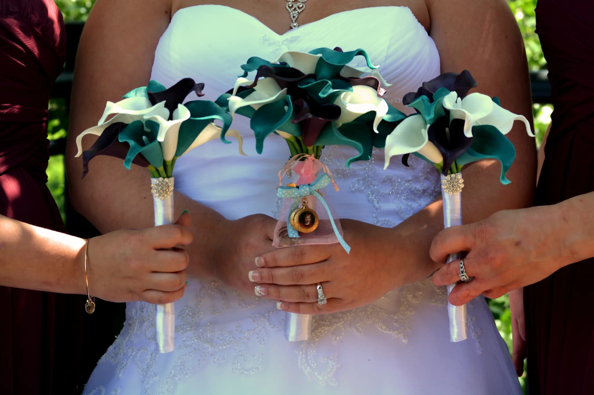Bride and bridesmaids holding teal and purple calla lily bouquets at Moose Hollow Lodge in Pigeon Forge near Dollywood