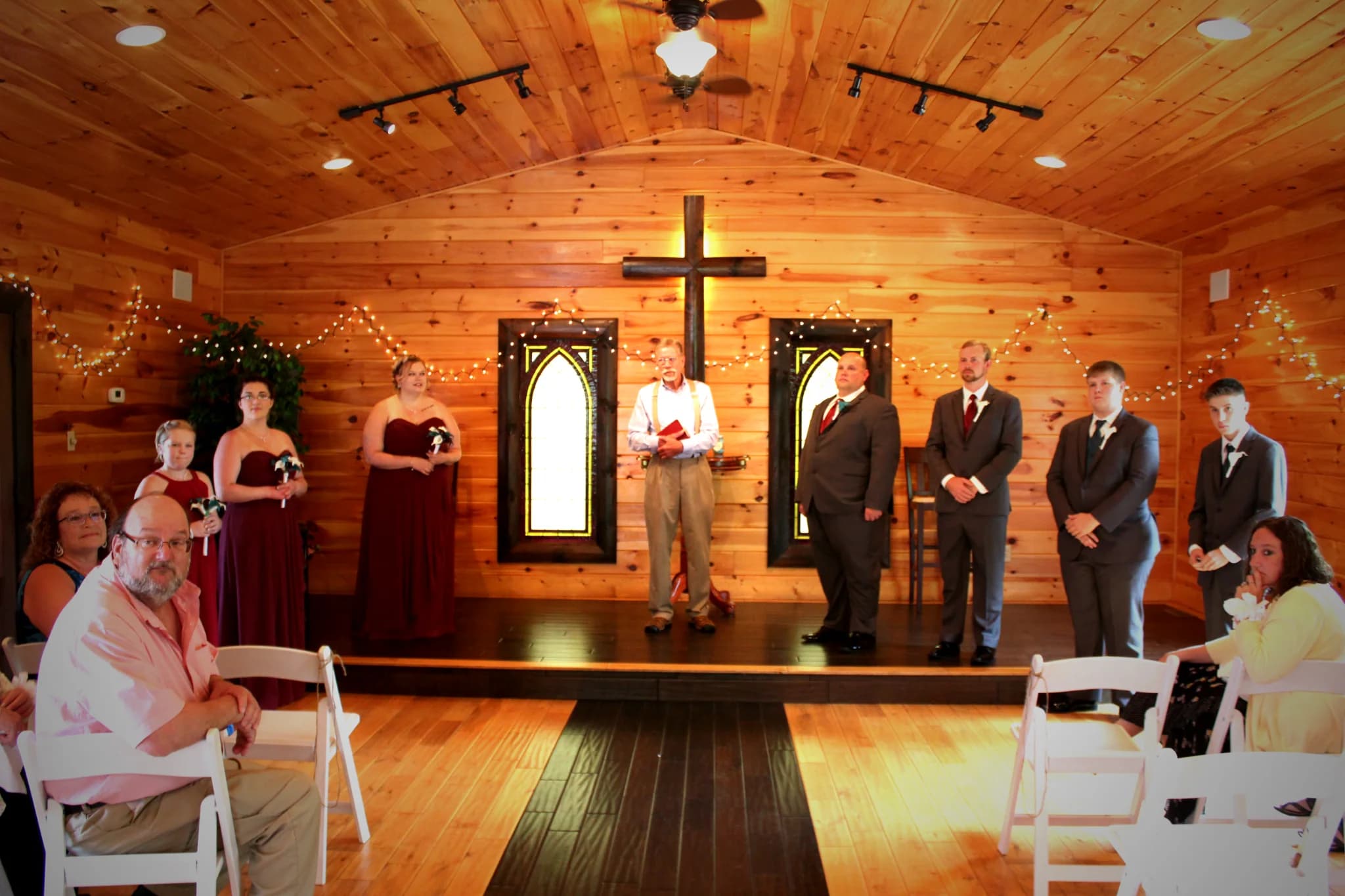 Rustic wedding chapel with wood paneling and a large wooden cross at Moose Hollow Lodge in Pigeon Forge.