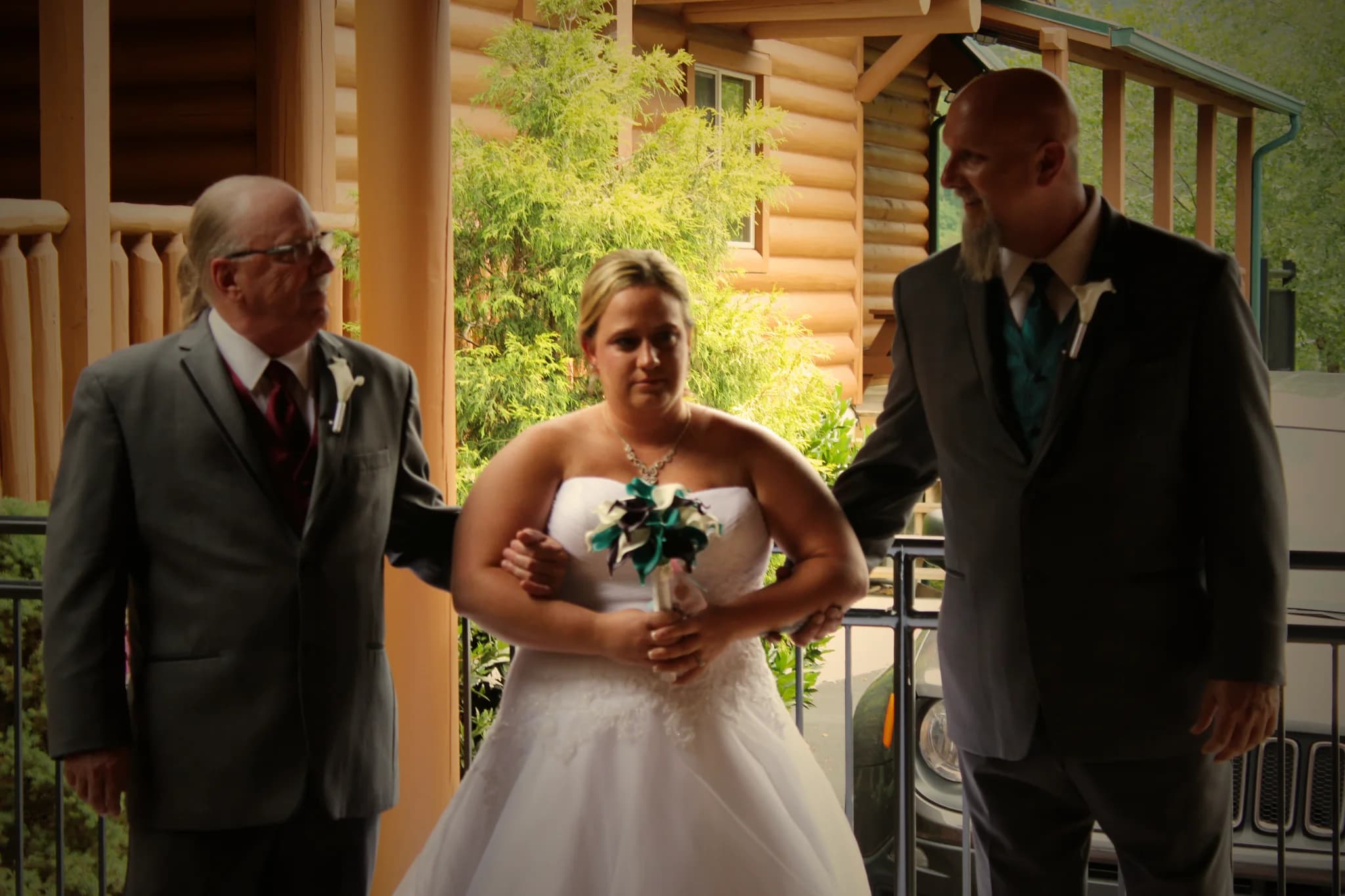 Bride escorted on log cabin deck for a wedding at Moose Hollow Lodge in Pigeon Forge near Dollywood