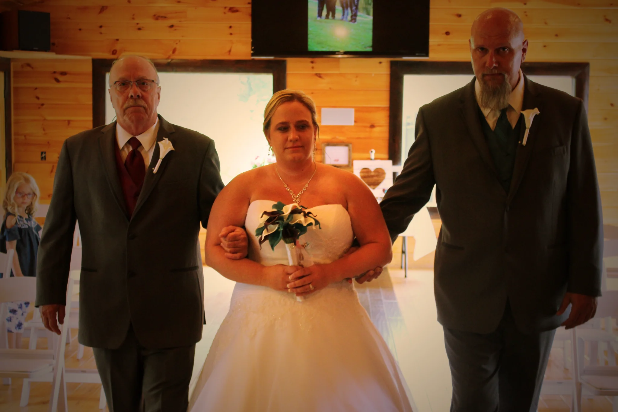 Bride walking down the aisle in a rustic indoor ceremony space at Moose Hollow Lodge in Pigeon Forge