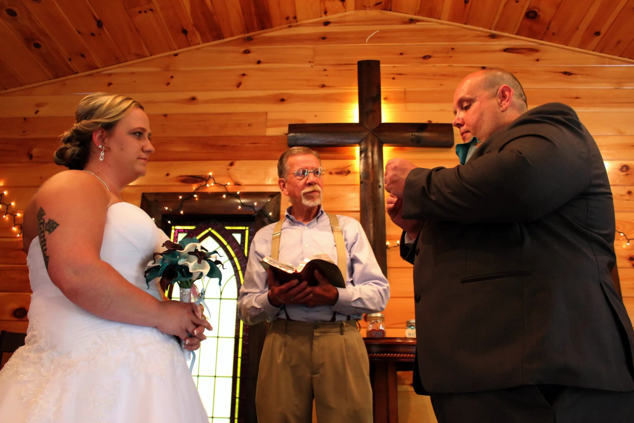Indoor wedding ceremony in rustic wood-paneled chapel at Moose Hollow Lodge in Pigeon Forge