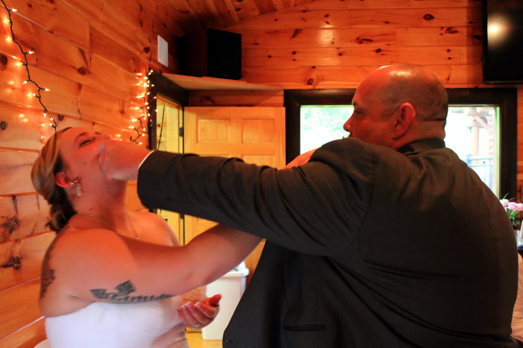Newlyweds feeding cake during wedding reception at Moose Hollow Lodge in Pigeon Forge