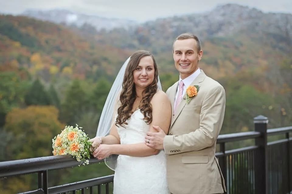 Wedding couple on deck with Great Smoky Mountains views near Dollywood at Moose Hollow Lodge in Pigeon Forge