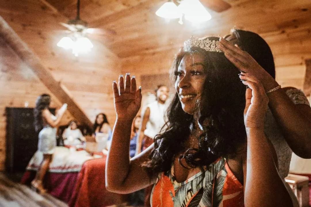 Bride getting ready in a rustic wood-paneled bedroom at Moose Hollow Lodge in Pigeon Forge