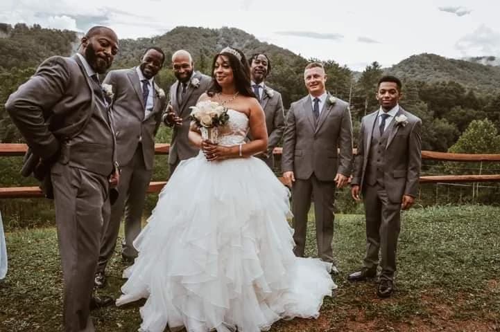 Bride and groomsmen posing with scenic Smoky Mountain views at Moose Hollow Lodge near Dollywood