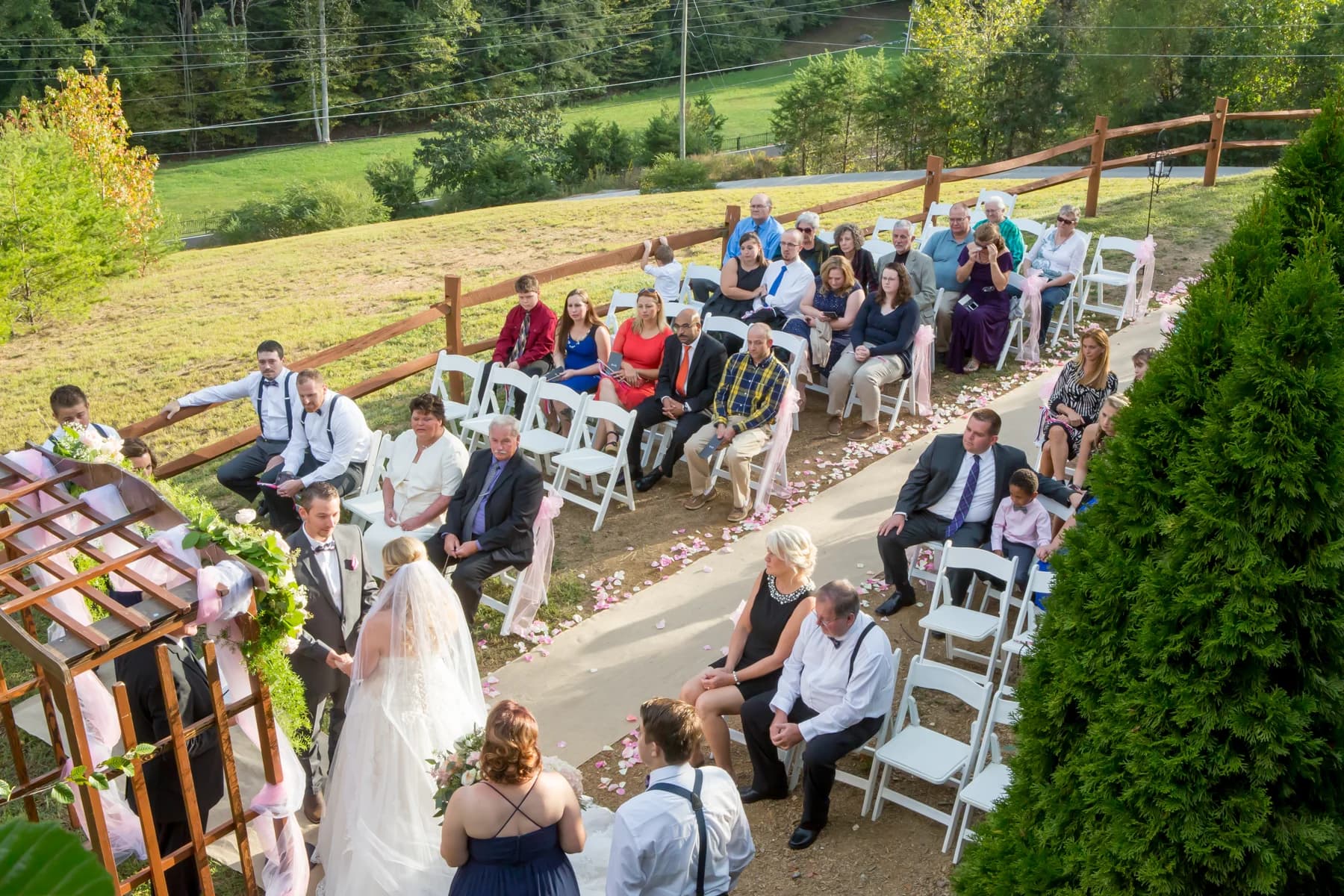 Outdoor wedding ceremony under a wooden arbor near the Smoky Mountains at Moose Hollow Lodge in Pigeon Forge