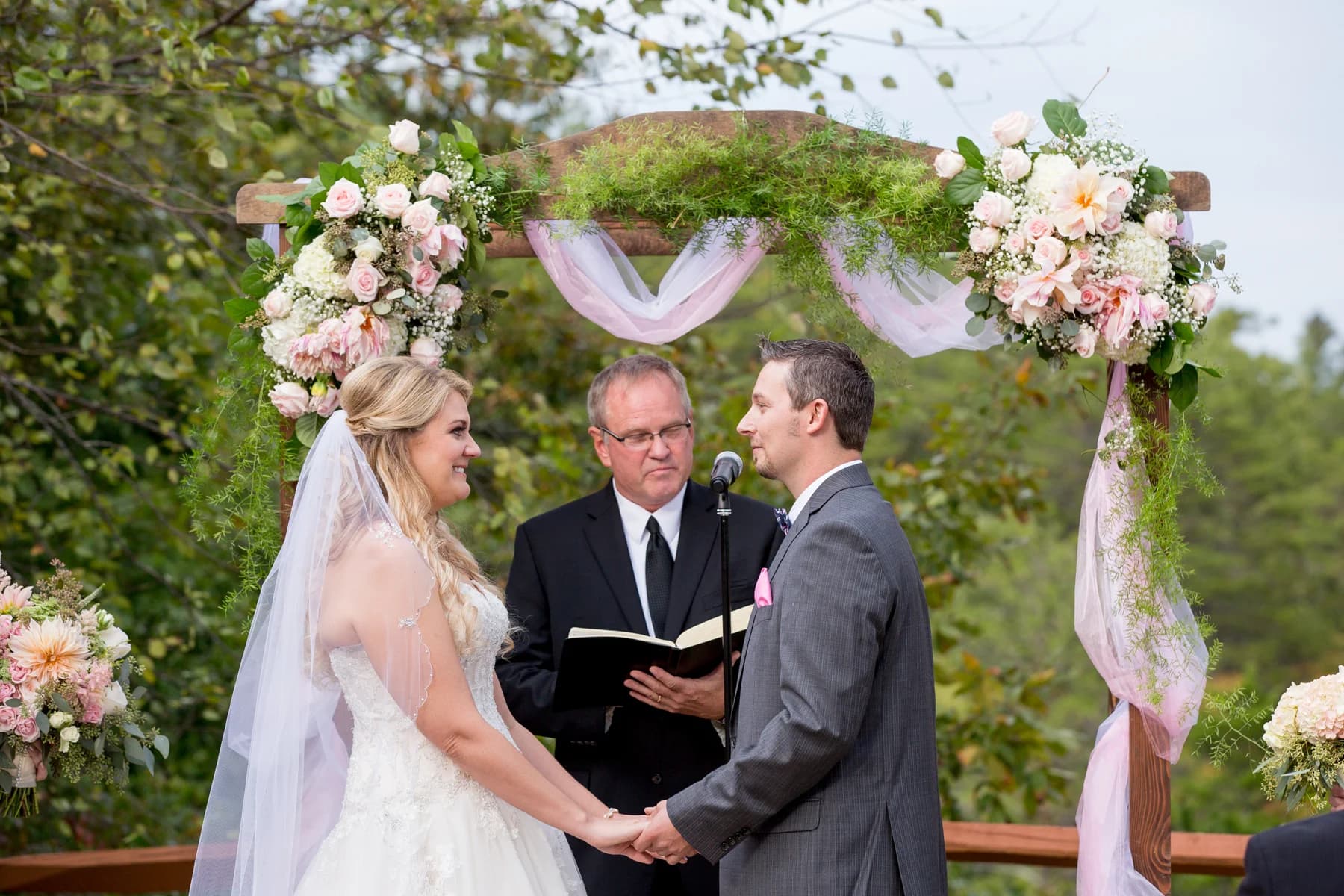 Outdoor wedding ceremony at a floral arch near Smoky Mountains at Moose Hollow Lodge in Pigeon Forge.
