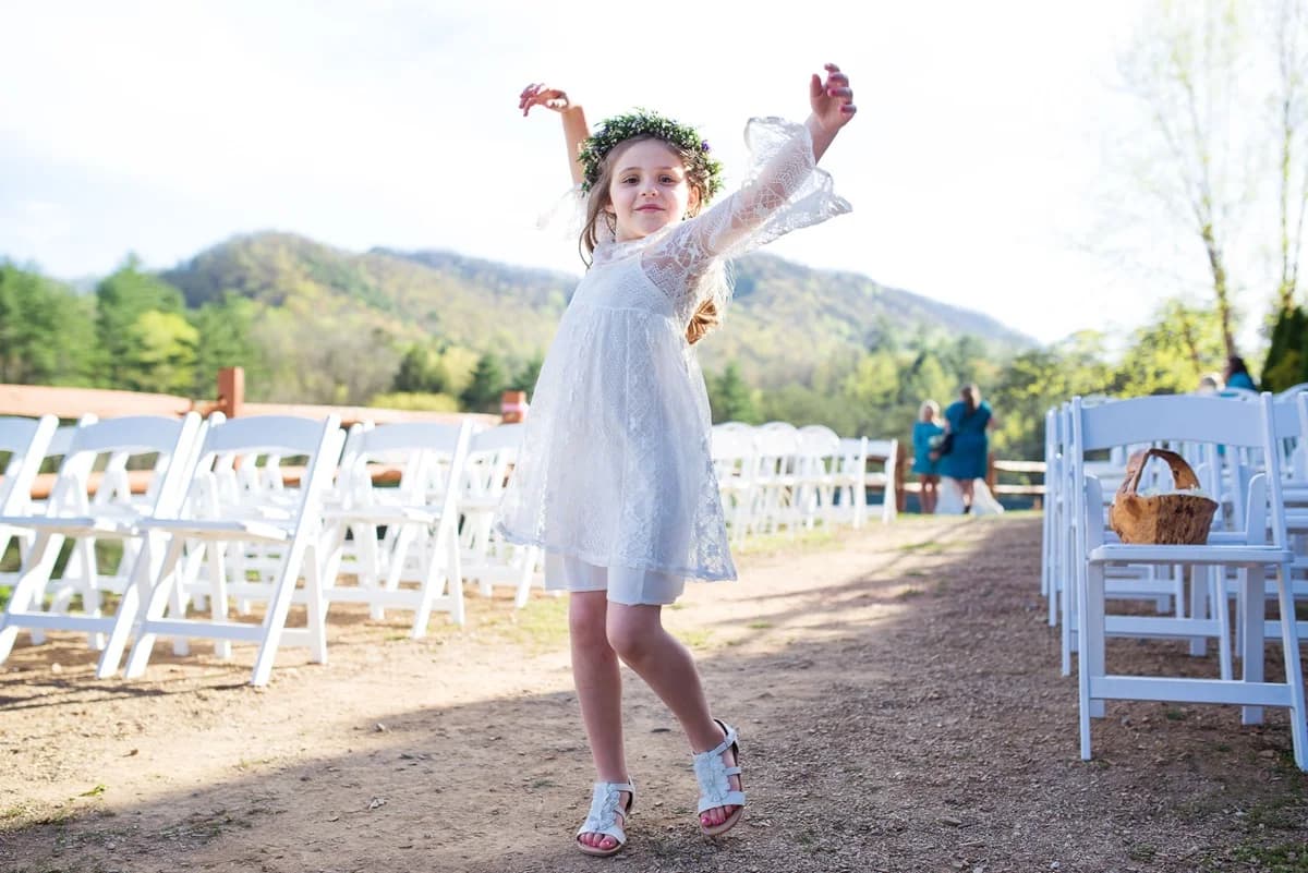 Flower girl at outdoor wedding ceremony with mountain views at Moose Hollow Lodge in Pigeon Forge near Dollywood