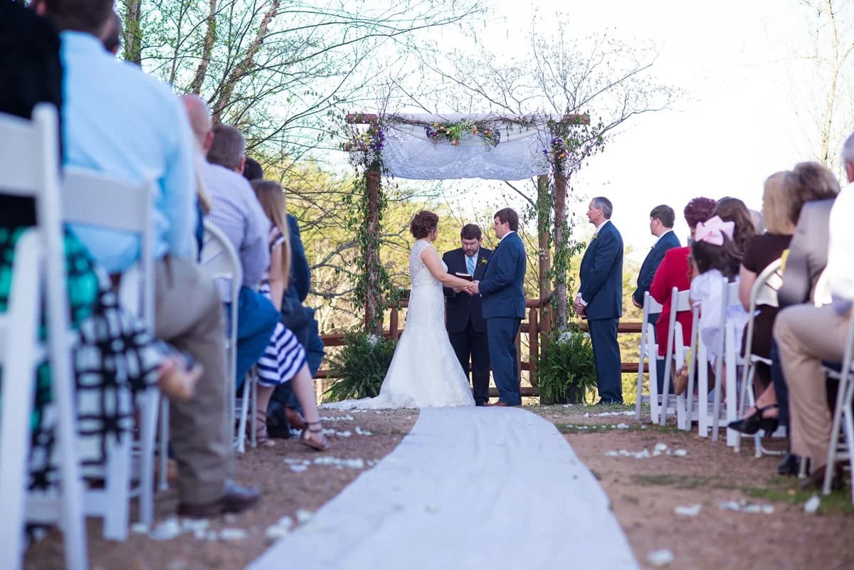 Outdoor wedding ceremony with floral arbor and forest views at Moose Hollow Lodge in Pigeon Forge near the Smoky Mountains