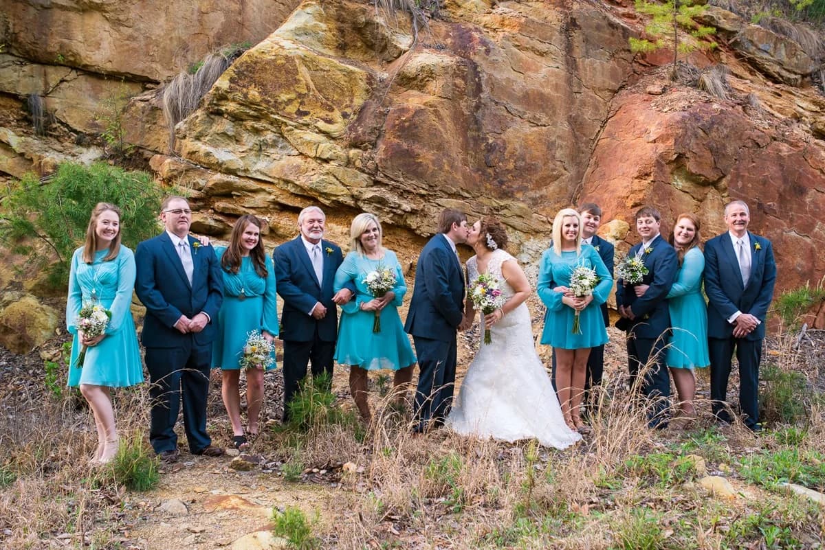 Wedding party posing by a natural rock cliff at Moose Hollow Lodge in Pigeon Forge near Smoky Mountains.