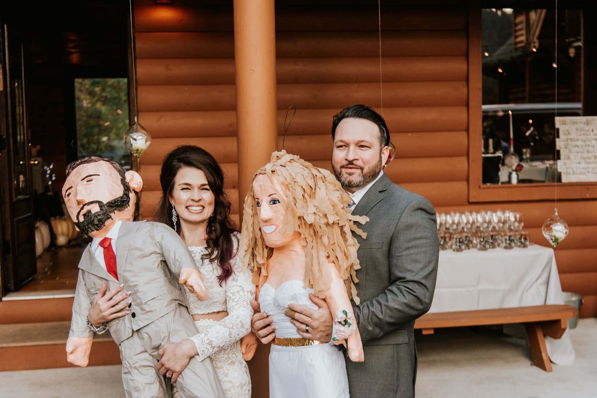 Bride and groom with custom piñatas on log cabin deck at Moose Hollow Lodge in Pigeon Forge near Smoky Mountains