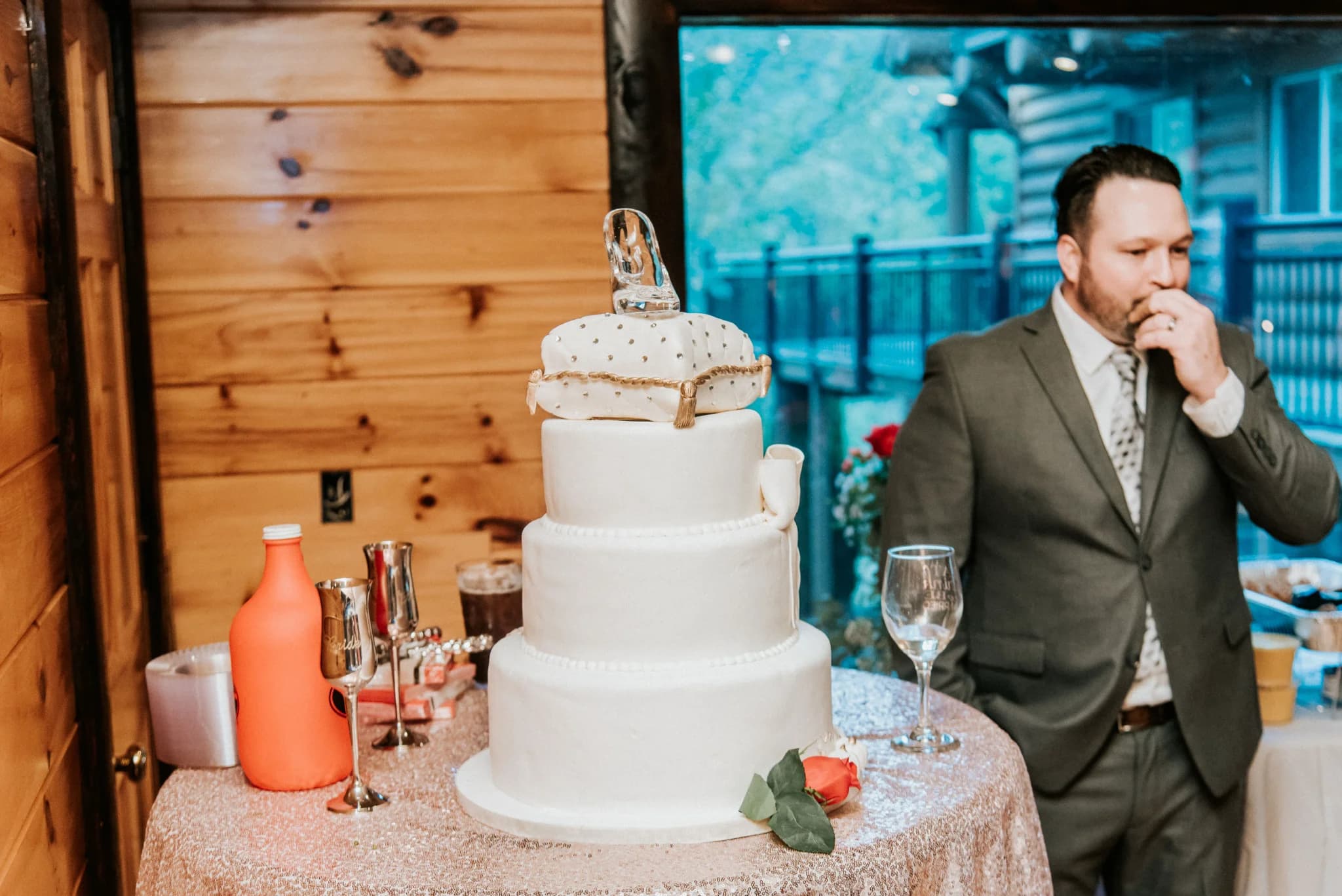 Three-tier white wedding cake in rustic cabin reception room at Moose Hollow Lodge in Pigeon Forge