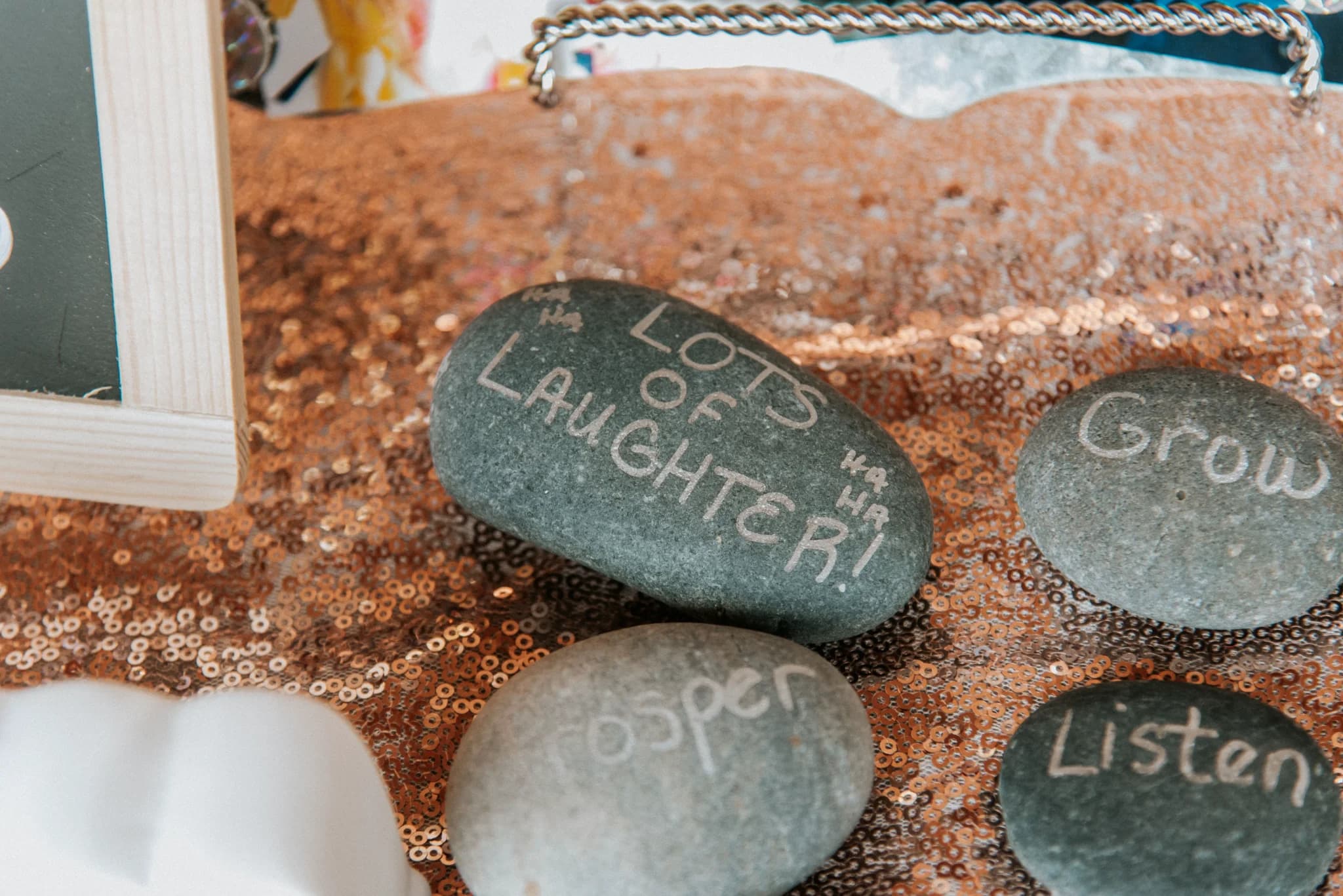 River rocks with handwritten wedding messages on rose gold sequins at Moose Hollow Lodge in Pigeon Forge