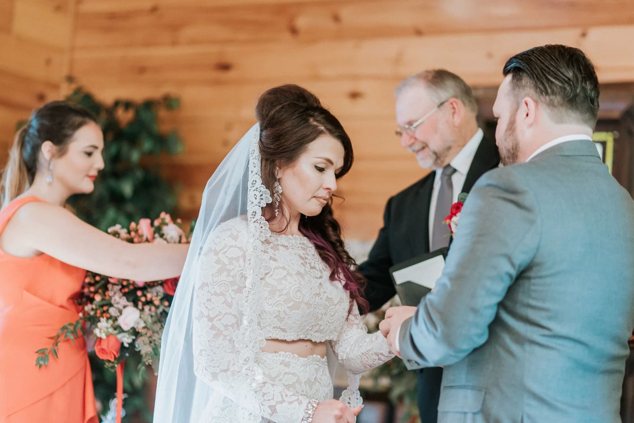 Indoor wedding ceremony with bride and groom in rustic log-walled venue at Moose Hollow Lodge in Pigeon Forge
