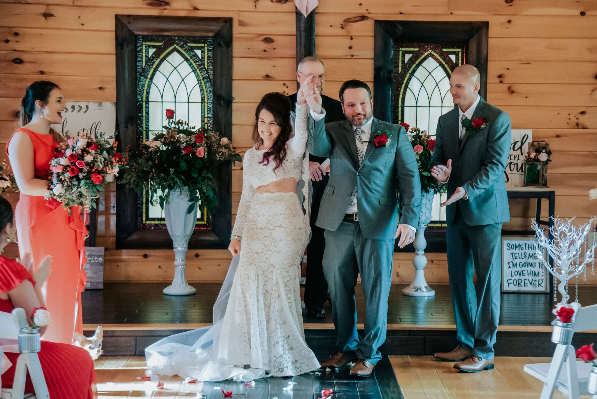 Rustic indoor wedding ceremony space with stained glass windows at Moose Hollow Lodge in Pigeon Forge