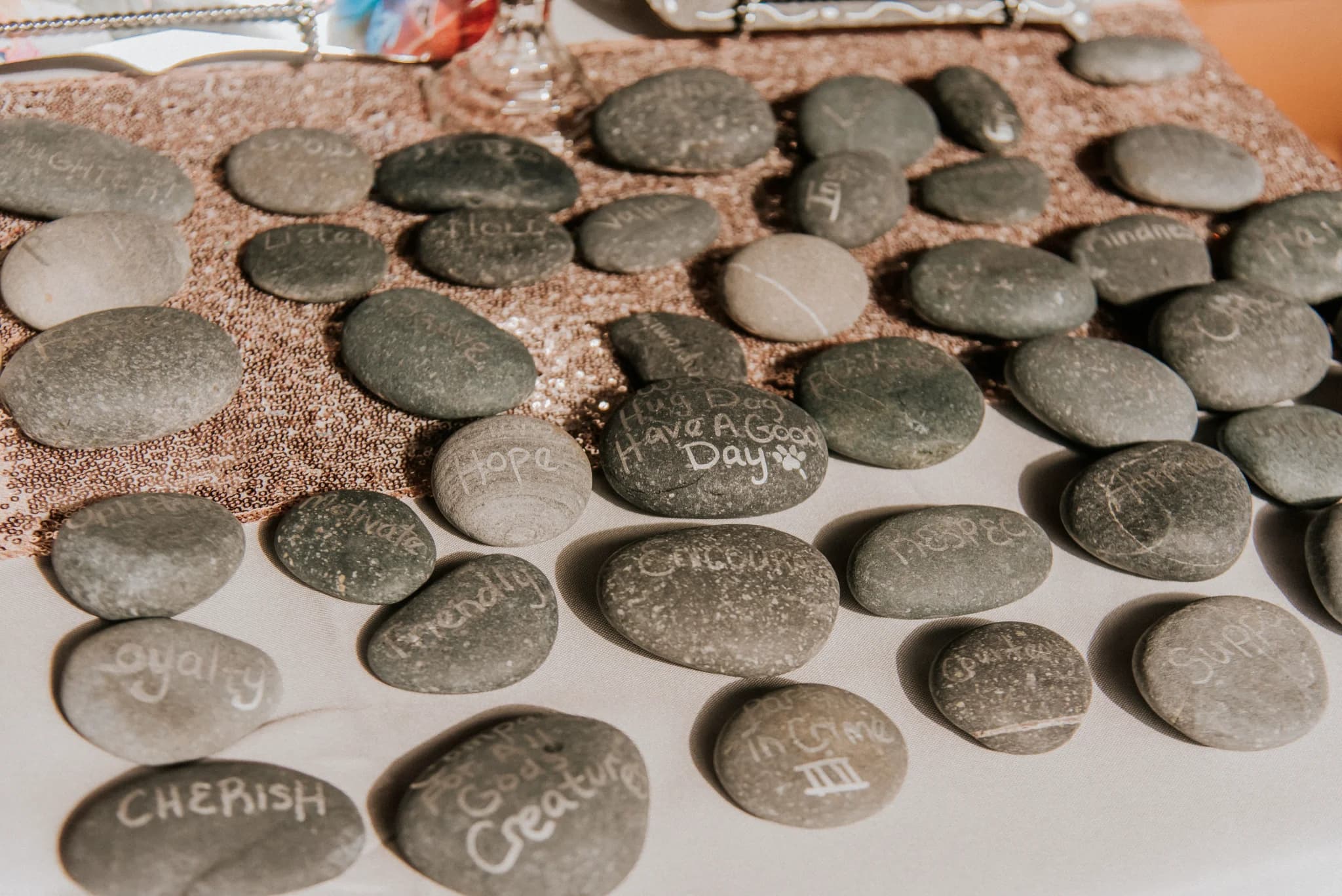 Wedding guest book stones with handwritten messages on sequin runner at Moose Hollow Lodge in Pigeon Forge