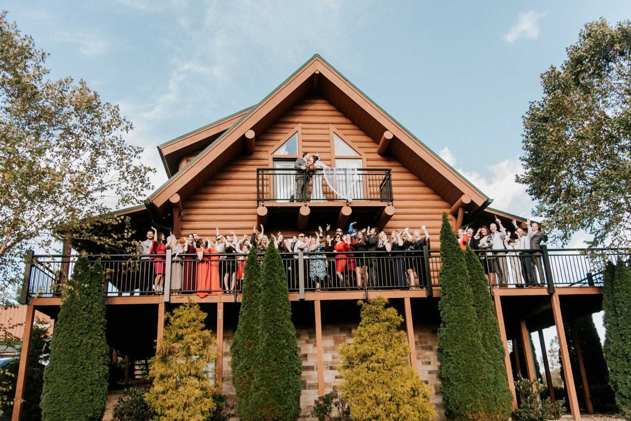 Wedding group cheering on cabin deck at Moose Hollow Lodge in Pigeon Forge near Smoky Mountains