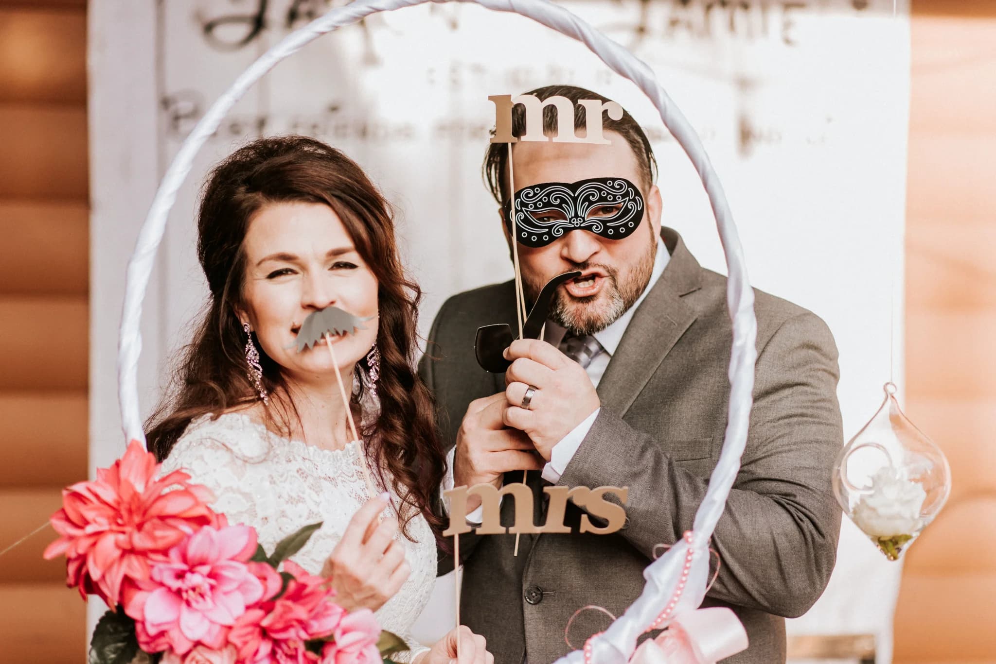 Wedding photo booth with fun props and floral decor at Moose Hollow Lodge in Pigeon Forge