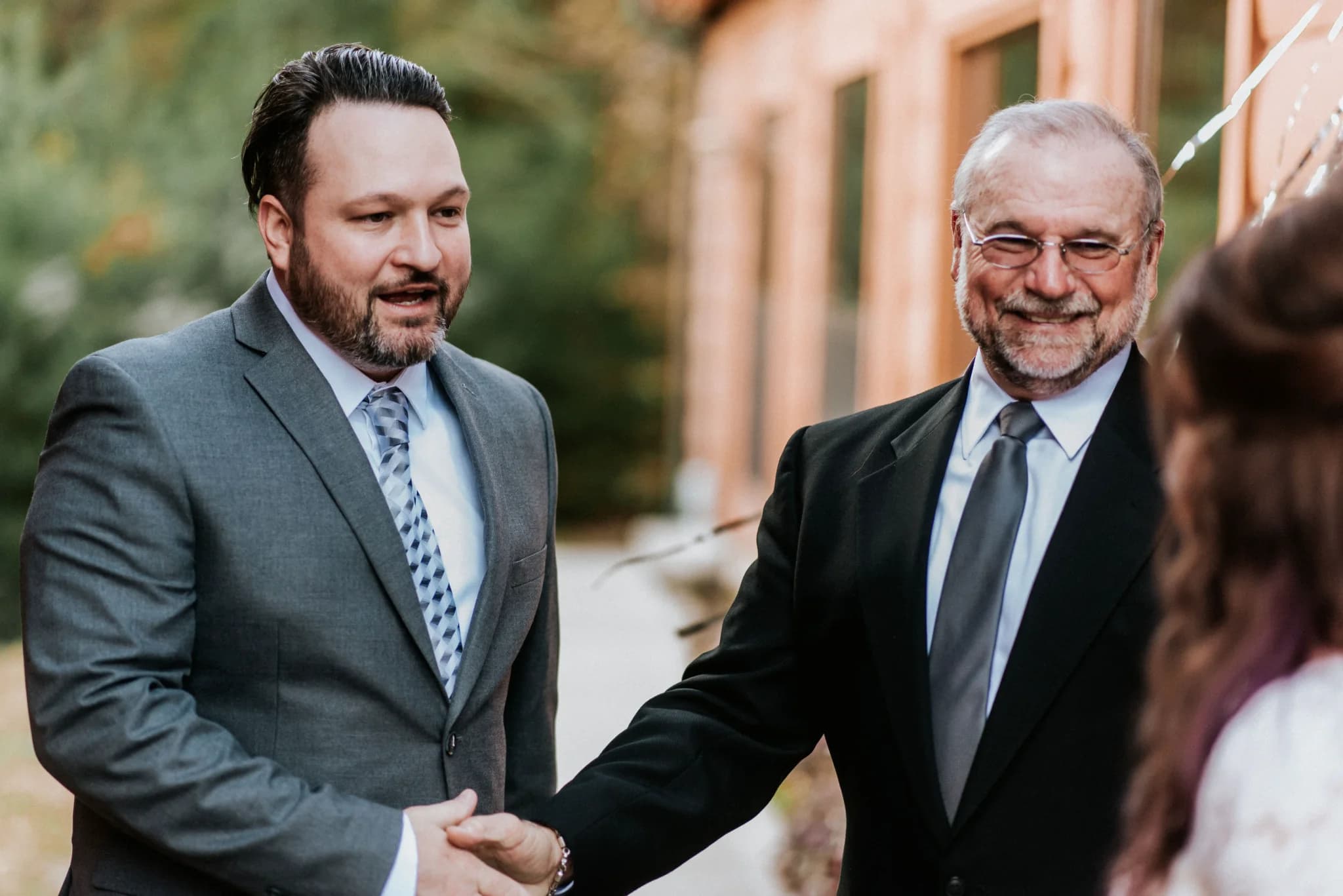 Men shaking hands at an outdoor wedding ceremony at Moose Hollow Lodge in Pigeon Forge near the Smoky Mountains.