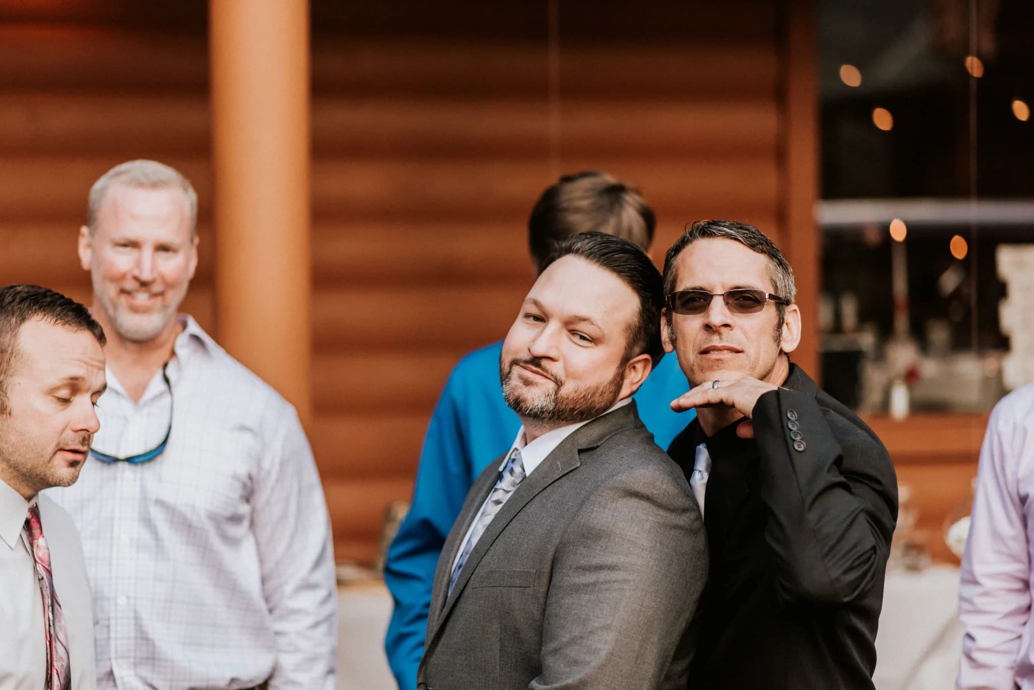 Wedding guests posing by the log cabin exterior at Moose Hollow Lodge in Pigeon Forge near Smoky Mountains