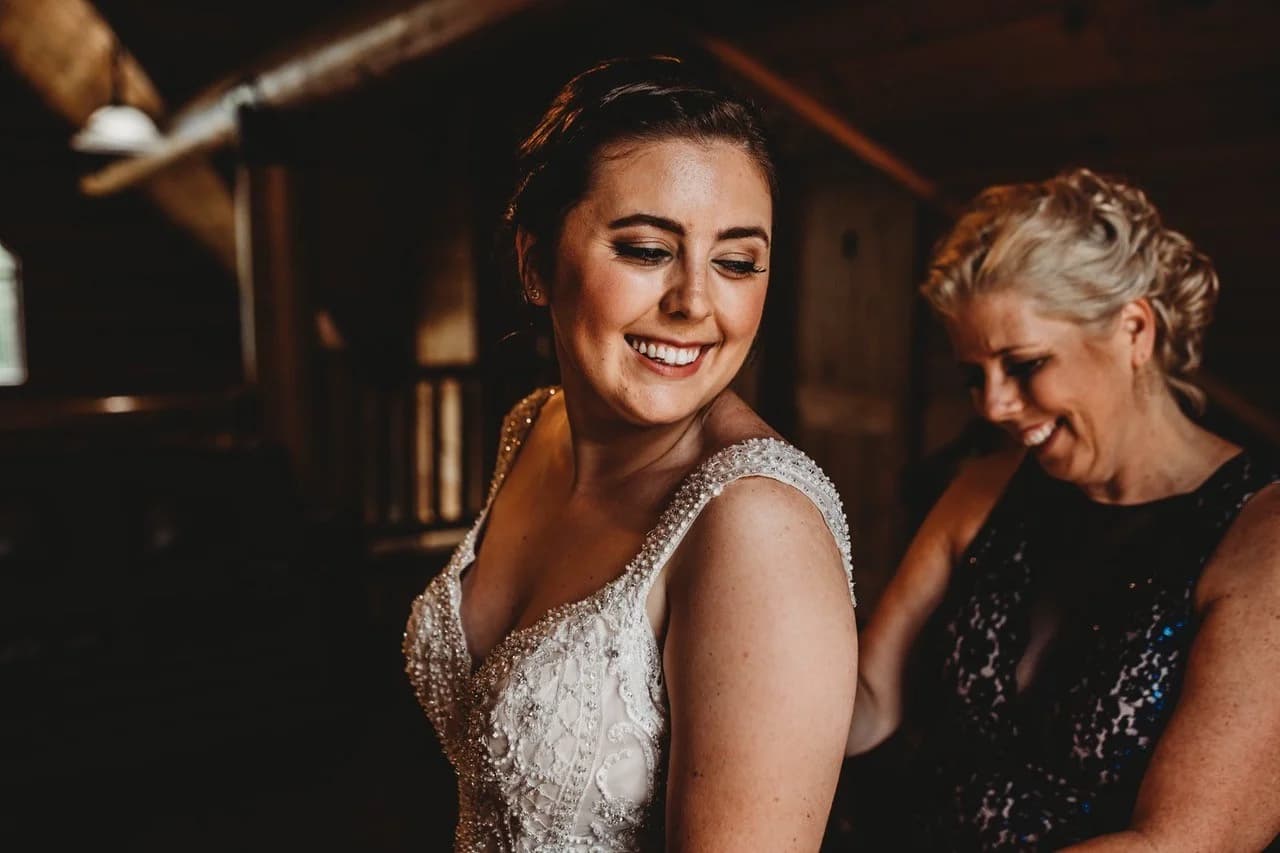 Bride in beaded dress getting ready in rustic lodge interior at Moose Hollow Lodge in Pigeon Forge