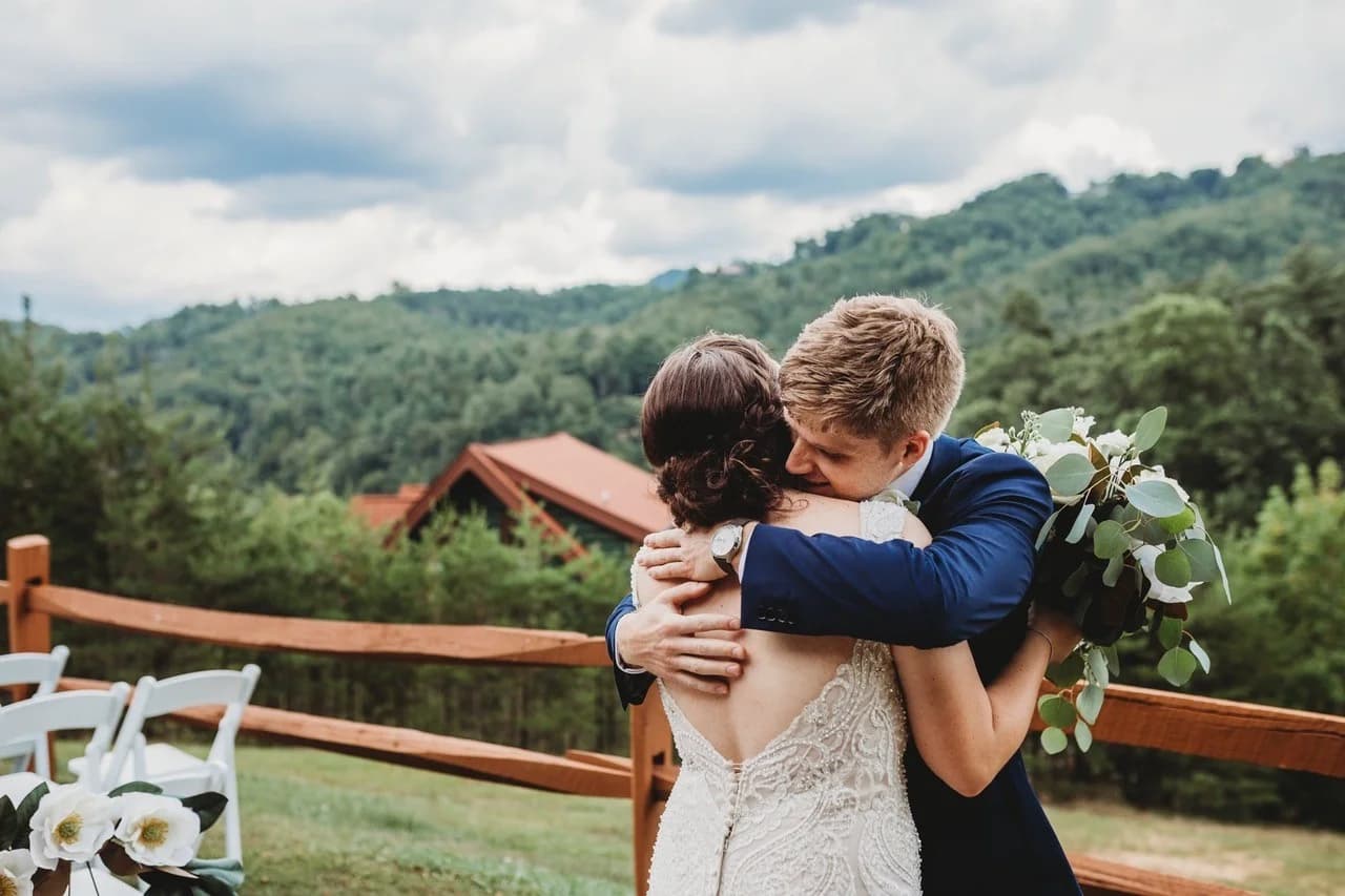 Bride and groom embrace at outdoor wedding with Smoky Mountain views near Dollywood at Moose Hollow Lodge in Pigeon Forge
