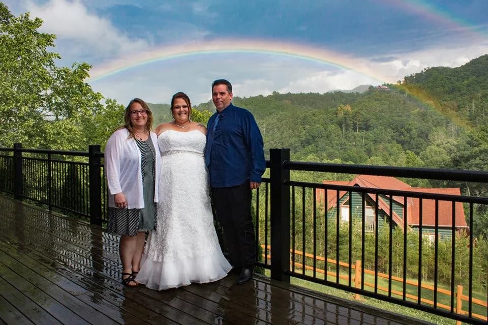 Bride on a deck with a rainbow over the Smoky Mountains at Moose Hollow Lodge near Dollywood in Pigeon Forge