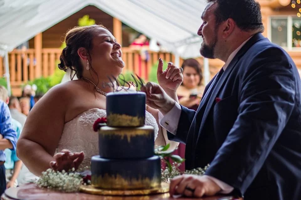 Bride and groom cutting wedding cake during reception at Moose Hollow Lodge in Pigeon Forge near Smoky Mountains