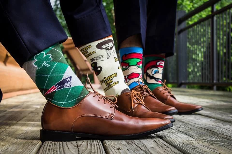 Groomsmen in novelty socks and dress shoes on a deck at Moose Hollow Lodge in Pigeon Forge near Smoky Mountains