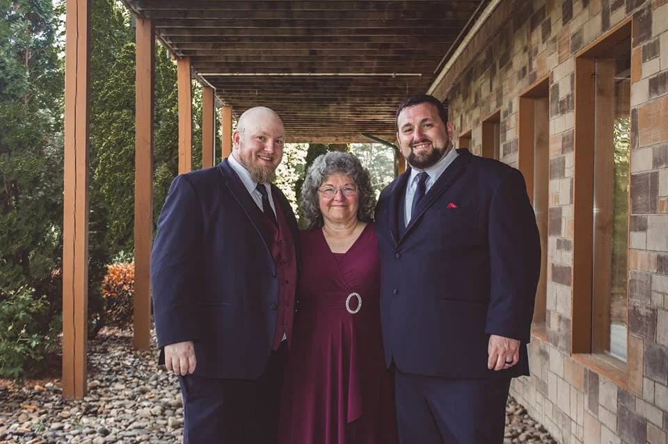 Wedding party on a stone walkway under a rustic deck at Moose Hollow Lodge in Pigeon Forge near the Smoky Mountains