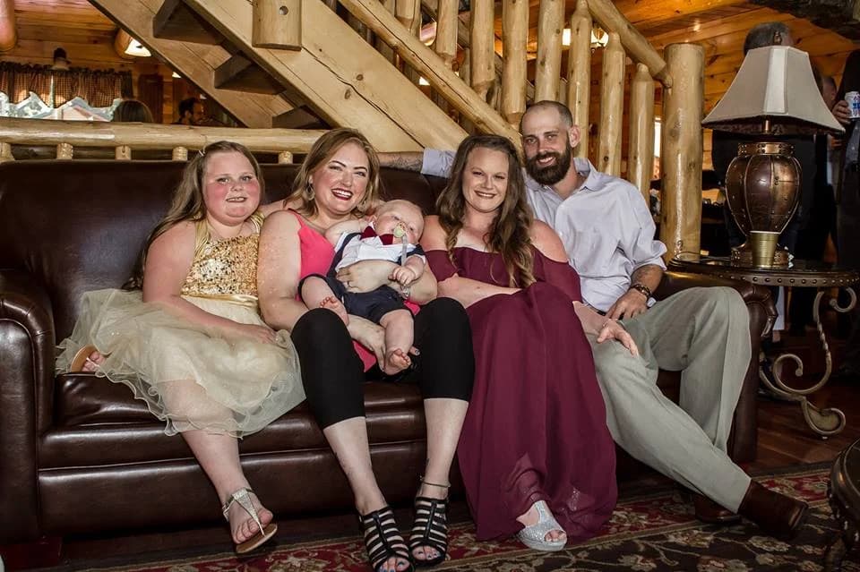 Guests relaxing on a leather sofa in the rustic lodge interior at Moose Hollow Lodge in Pigeon Forge