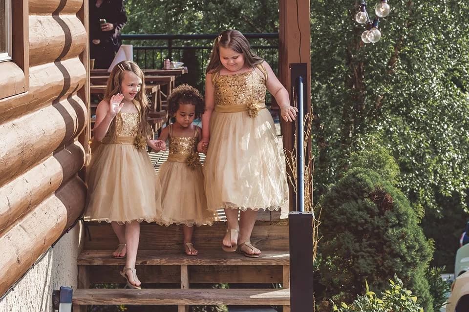 Flower girls on cabin steps for a Smoky Mountains wedding at Moose Hollow Lodge in Pigeon Forge near Dollywood.
