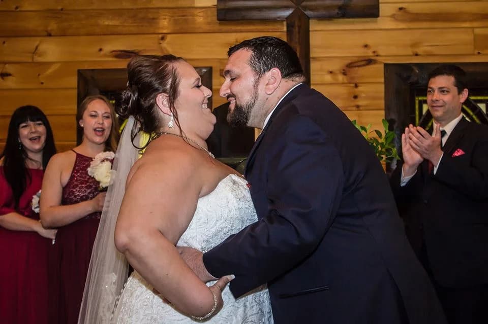 Wedding ceremony in a rustic indoor chapel with wood walls at Moose Hollow Lodge in Pigeon Forge