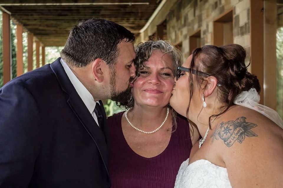Wedding couple kissing family on a deck at Moose Hollow Lodge in Pigeon Forge near Dollywood and Smoky Mountains