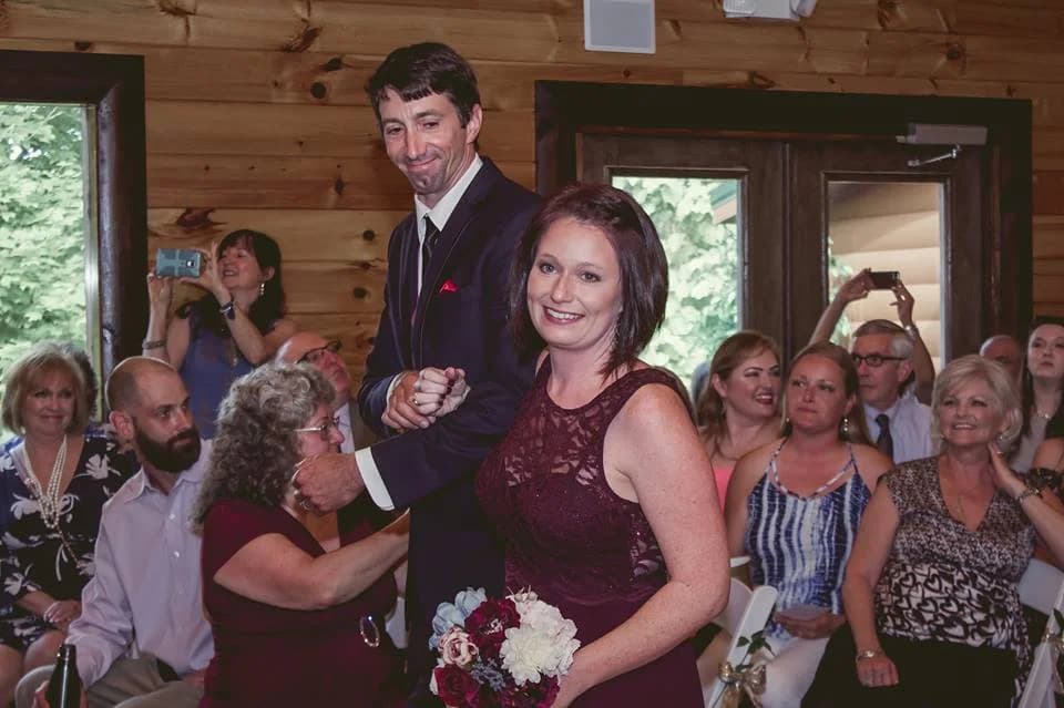Wedding ceremony in a rustic log cabin event venue with guests at Moose Hollow Lodge in Pigeon Forge
