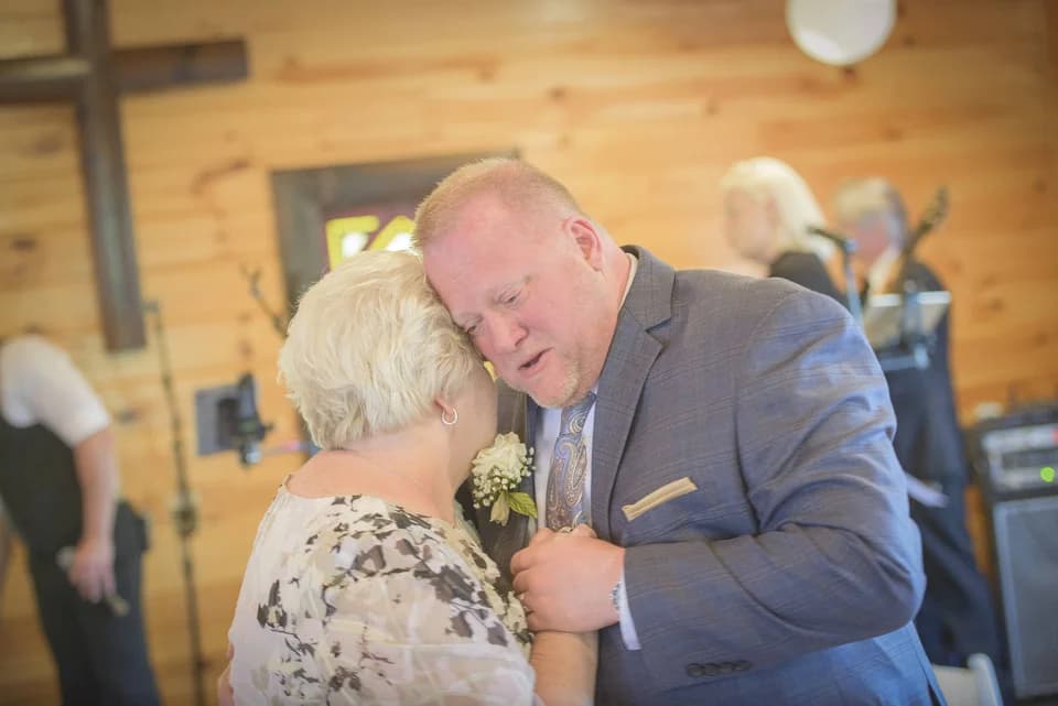 Couple dancing in a rustic indoor wedding chapel at Moose Hollow Lodge in Pigeon Forge